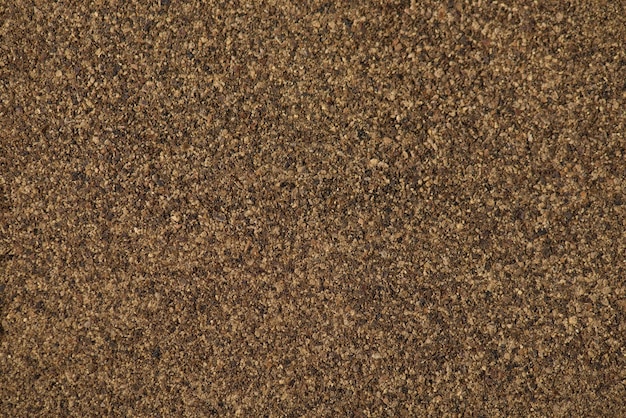 Top close-up acima da foto da vista do fundo texturizado de pimenta em pó preto