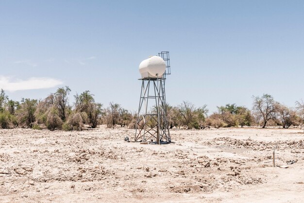 Torre de agua en tierra contra el cielo durante un día soleado