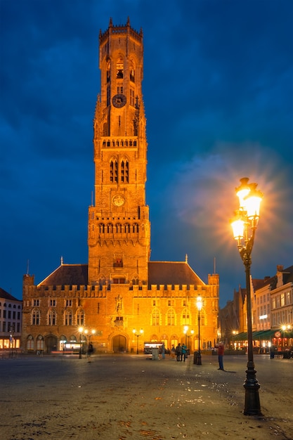 Torre do campanário e praça grote markt em bruges, bélgica ao anoitecer ao crepúsculo