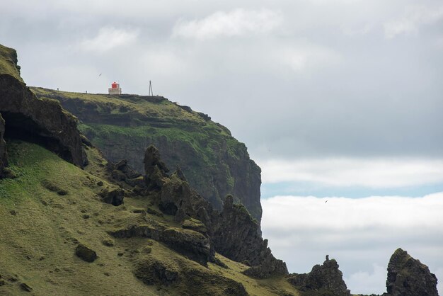 Foto torre del faro de dyrholaey en la costa atlántica de islandia