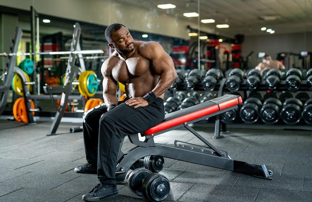 Torso desnudo musculoso culturista posando en el gimnasio Hombre atlético fuerte con cuerpo musculoso