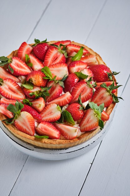 Torta de morango com creme de manteiga em uma mesa de madeira branca deliciosa sobremesa francesa