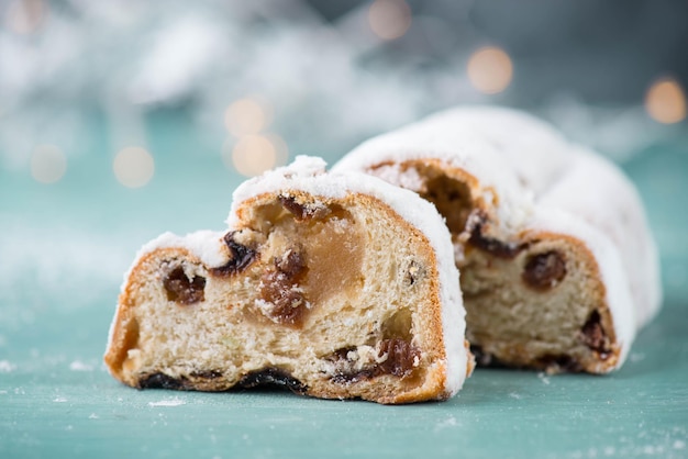 Torta de Natal tradicional de Christstollen com nozes, razões, marcipão sobre um fundo azul