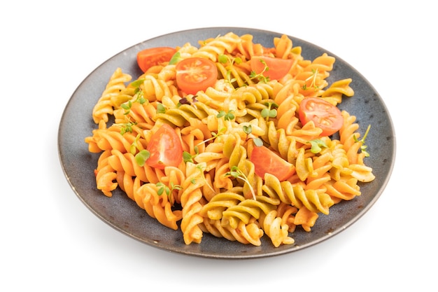 Tortiglioni Grießnudeln mit Tomaten und mikrogrünen Sprossen isoliert auf weißer Oberfläche