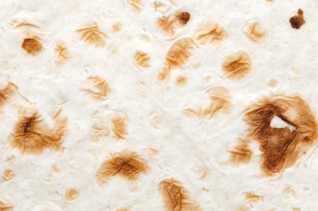 Tortilha de pão pita artesanal assada em tandoor manchas assadas closeup estrutura fundo papel de parede padrão de textura uniforme