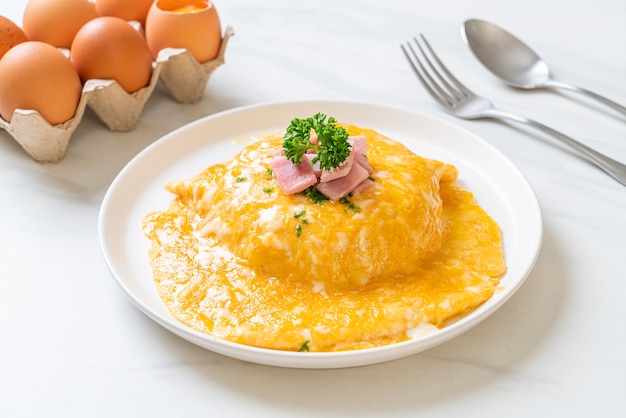 Foto tortilla cremosa con jamón sobre arroz o arroz con jamón y tortilla suave
