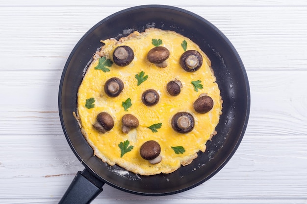 Tortilla con setas y perejil en una sartén Frittata