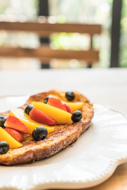 Tostada francesa con melocotón, fresa y arándanos.