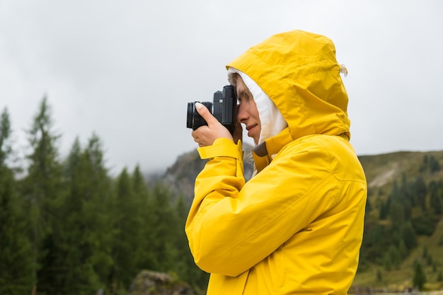 Tourist macht Fotos von Wiesen der Alpenberge