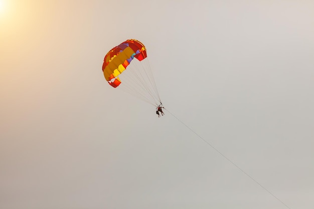 Touristen fliegen mit dem Fallschirm über das Meer und den Strand. Sport und Erholung für Touristen in der Türkei