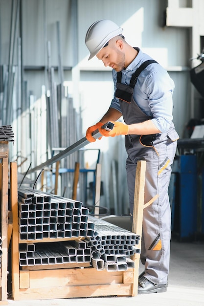 Foto trabajador de fábrica mide el perfil de metal