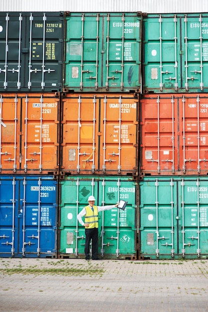 Foto trabajador de logística en transporte marítimo o gerente de almacén de contenedores en un puerto que trabaja con seguridad en el negocio global de transporte de carga marítima carga lista para entrega internacional, exportación y comercio