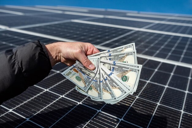 Foto un trabajador maravilloso tiene una cantidad redonda de dinero para la instalación de paneles solares en sus manos