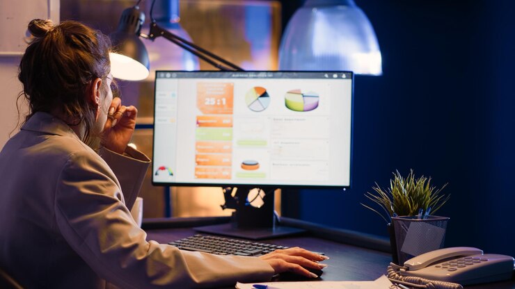 Foto trabajador de oficina mirando diagramas en ejecución de la computadora