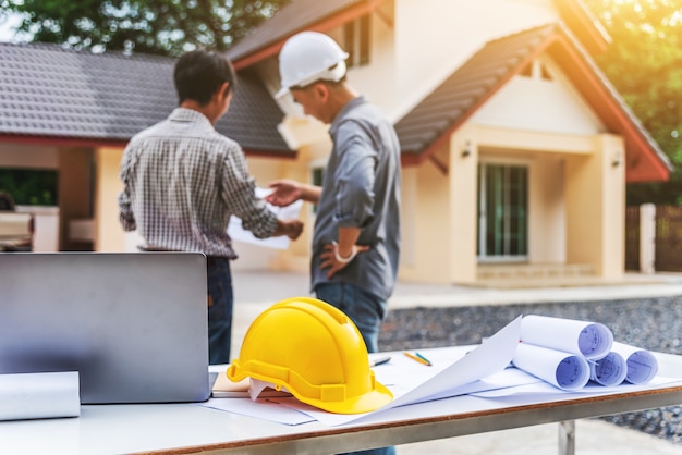 Trabajador profesional del ingeniero de dos hombres de negocios en la construcción de viviendas.