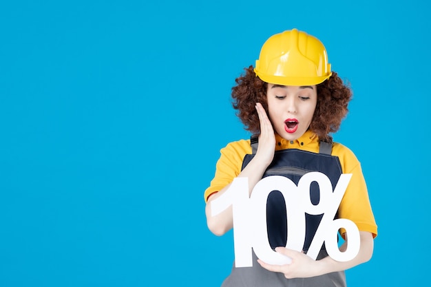 Trabajadora en uniforme amarillo con signo en azul