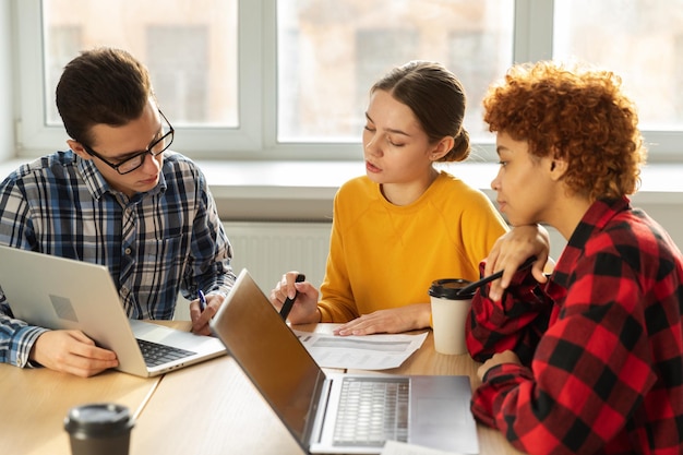 Trabajo en equipo lluvia de ideas diversos colegas trabajando juntos discutir estadísticas financieras grupo de feliz