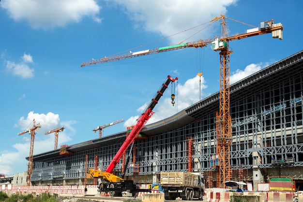 Trabajos de construcción de grúas y edificios y cielo azul.