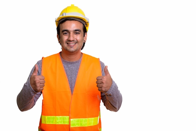 Trabalhador da construção civil do homem persa feliz sorrindo enquanto faz sinal de positivo