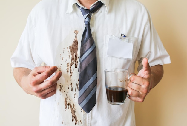 Trabalhador de escritório derrama café na camisa branca. burnout ocupacional. gerente com caneca nas mãos. trabalho estressante.