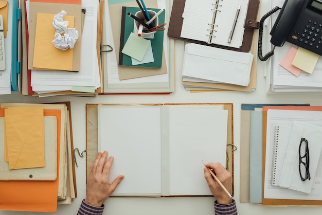 Trabalhador de escritório escrevendo papelada