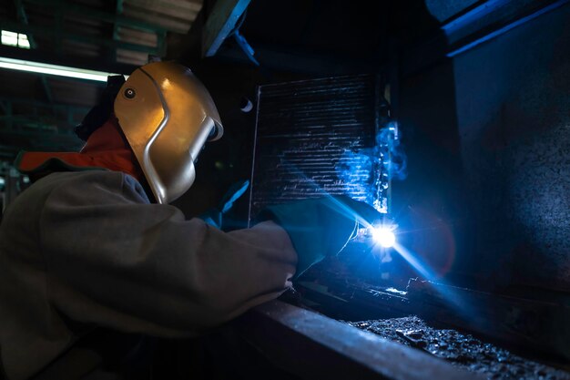 Foto trabalhador industrial na fábrica de solda.