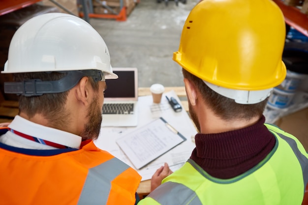 Trabalhadores da construção civil discutindo planos