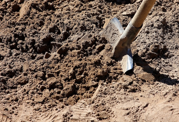 Trabalhe na escavação da terra com uma pá no solo