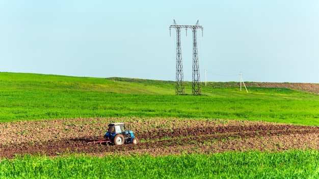 Tractor arados campos agrícolas en la primavera