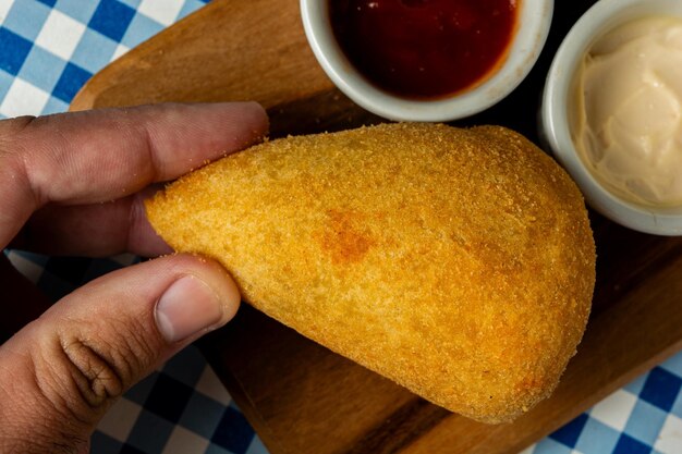 Foto tradicional coxinha brasileira típica salgadinho frito recheado com carne e frango