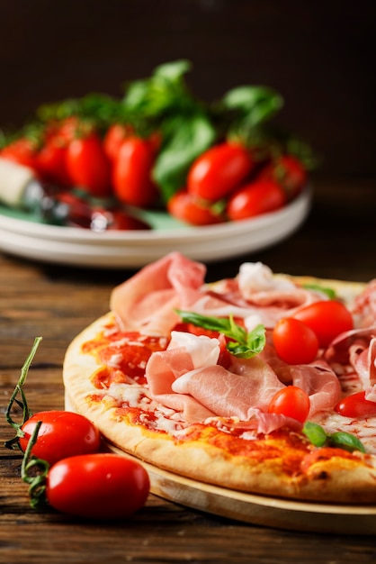 Tradicional pizza italiana com mussarela, tomate e bacon, foco seletivo e copyspace