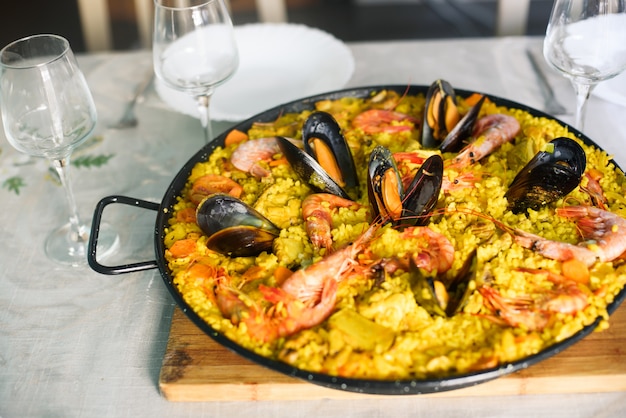 Foto tradicional plato de paella española con langostinos y mejillones.