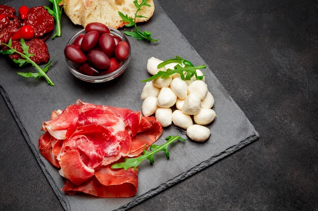 Traditionelle italienische Gerichte - Schinken Crudo oder Schinken, Parmesan, Tomaten