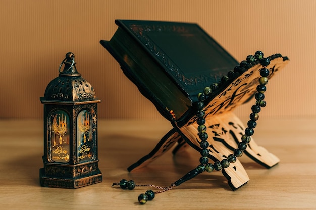 Foto traditionelle ramadan-lampe mit gebetsperlen auf hellem holzhintergrund