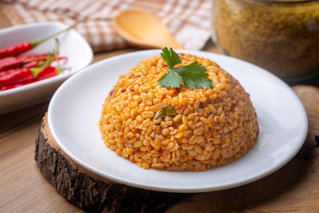 Traditioneller türkischer Bulgur-Pilaf mit Tomatensauce auf dem Teller, türkischer Name meyhane pilavi