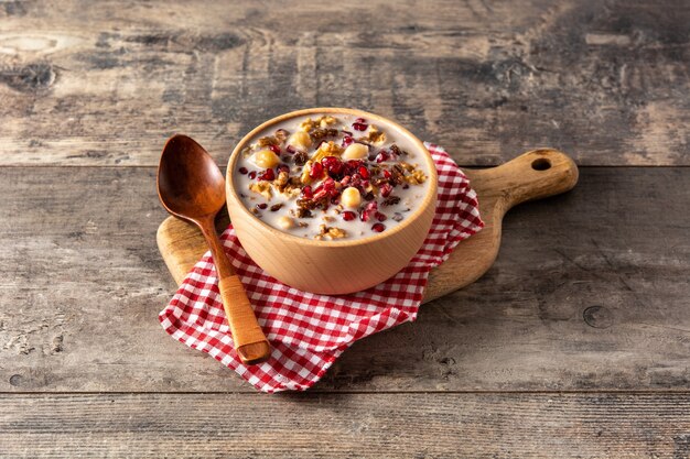 Traditioneller türkischer Noahs Pudding in Schüssel auf Holztisch