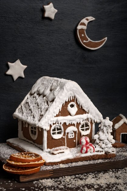 Traditionelles Backen. Lebkuchenhaus und Lebkuchensterne. Vertikaler Rahmen.