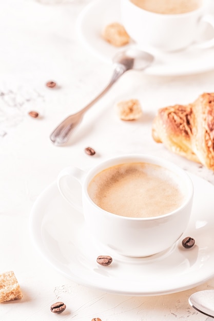 Traditionelles Frühstück mit frischen Croissants auf Weiß, vertikal.