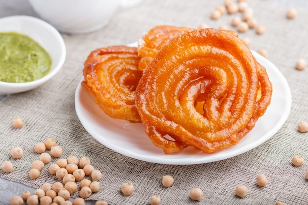 Traditionelles indisches Süßigkeitsjalebi in der weißen Platte mit tadellosem Chutney