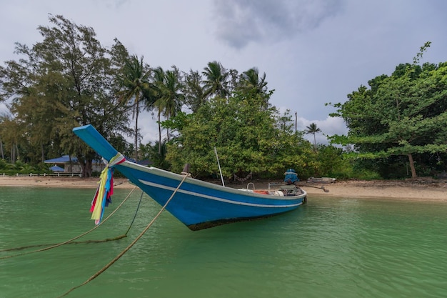 Traditionelles thailändisches Longtail-Boot mit bunten Bändern verzierte Nase am Sandstrand Samui Thailand