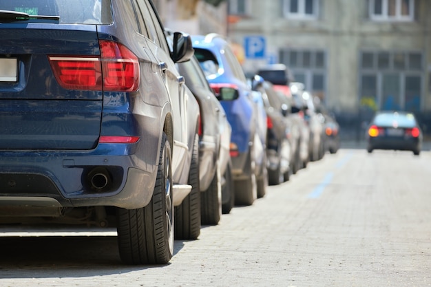 Tráfego da cidade com carros estacionados em fila do lado da rua.