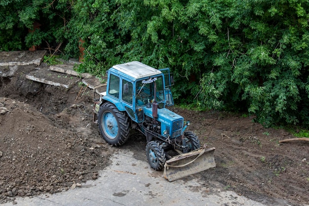 Traktor-Planierraupe mit montiertem Arbeitsgerät arbeitet bei Erdarbeiten