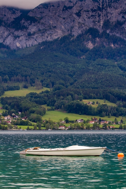 Tranquilo día nublado en la orilla del lago de Attersee con montañas en el fondo a finales de verano. Lago Attersee en el Salzkammergut austriaco