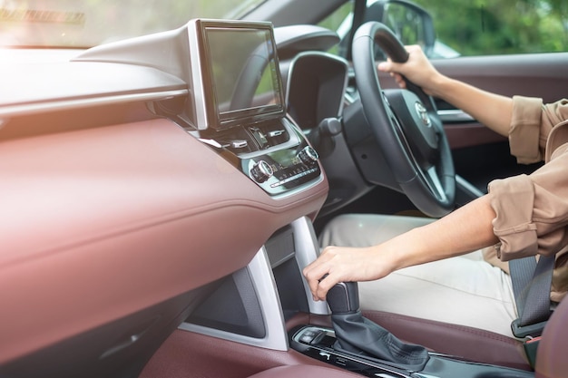 Transmissão de mudança de marcha do motorista mulher uma engrenagem do carro controlando o volante durante a movimentação do veículo Viagem de viagem e segurança Conceitos de transporte