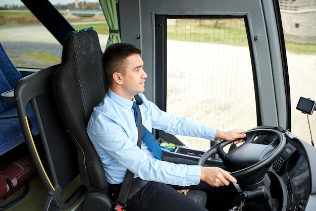 transporte, turismo, viaje por carretera y concepto de personas - conductor feliz conduciendo autobús interurbano
