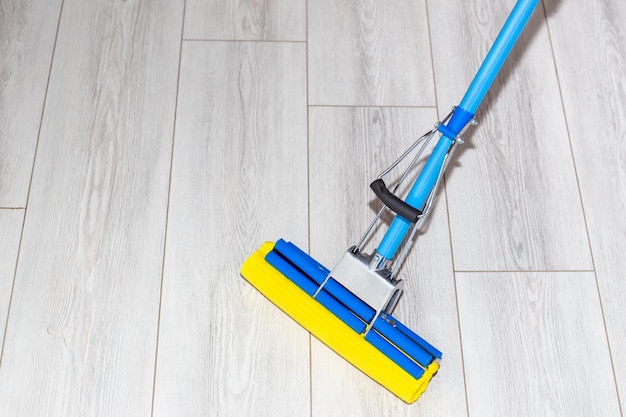 Foto el trapeador autoestrujable limpia el piso laminado limpiando la casa trapeando el piso