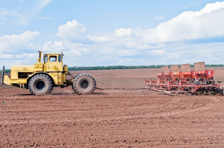 Foto trator com semeadora no campo