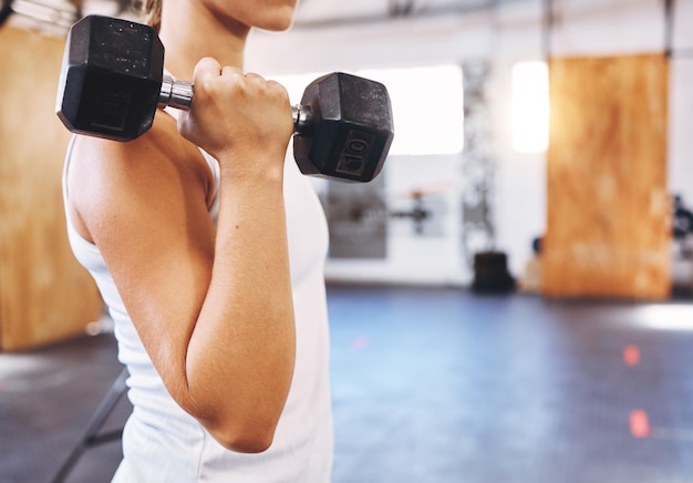 Treinamento de saúde e levantamento de peso por exercício de mulher com um haltere na academia ou centro de fitness Jovem atleta se junta à academia começa a jornada de saúde física metas físicas e corporais musculares