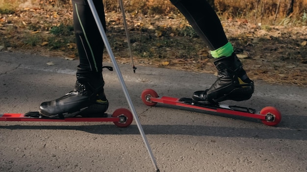 Foto treinando um atleta nos patinadores de patins passeio de biatlo nos esquis de patins com bastões de esqui