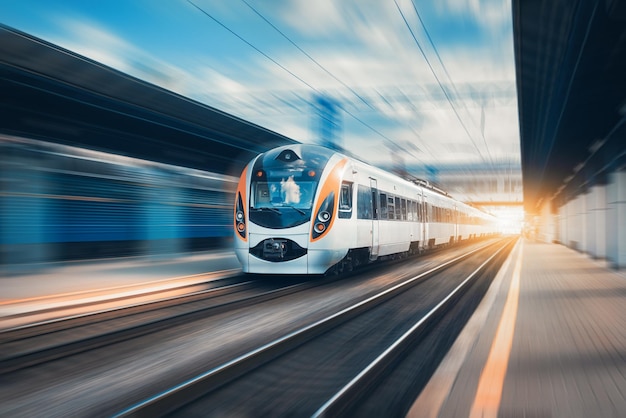 Trem de alta velocidade na estação ferroviária ao pôr do sol